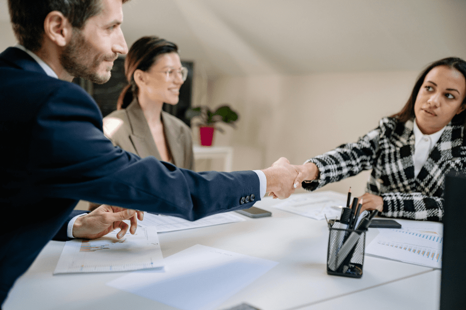 Businessman and businesswoman shaking hands